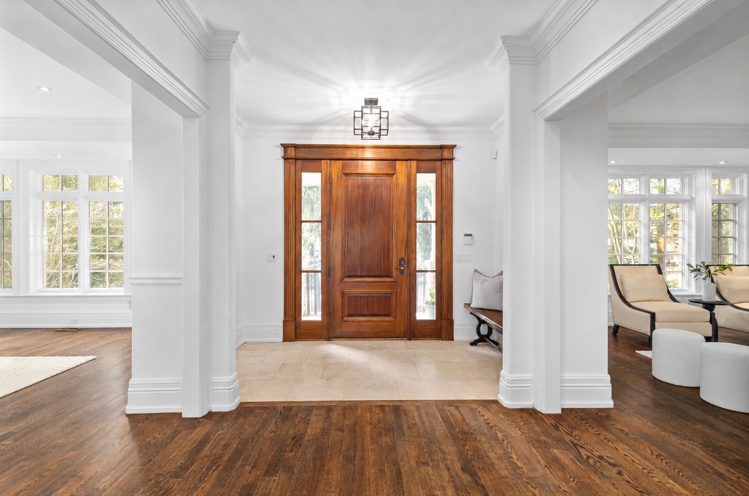 Bright entryway with crisp white trim and hardwood floors